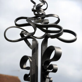 Wrought iron sculpture depicting the water of the River Wey, one of a series of sculptures bordering Bridge Street and Waitrose Car Park